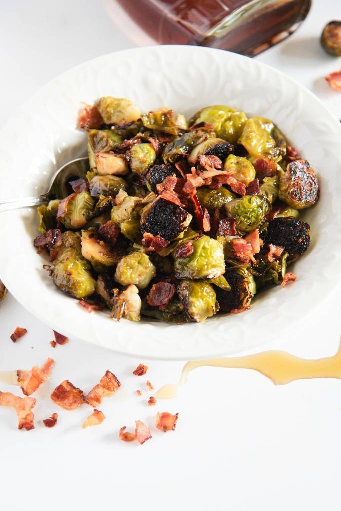 a overhead shot of a dish of brussels sprouts with a spoon in it 