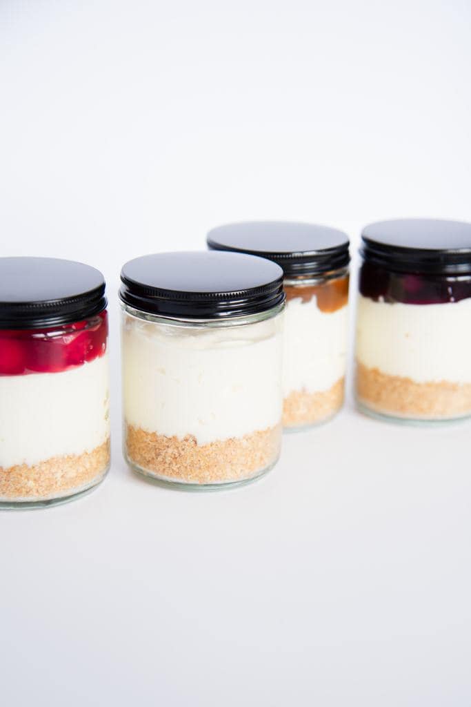 jar of cheesecake with different toppings