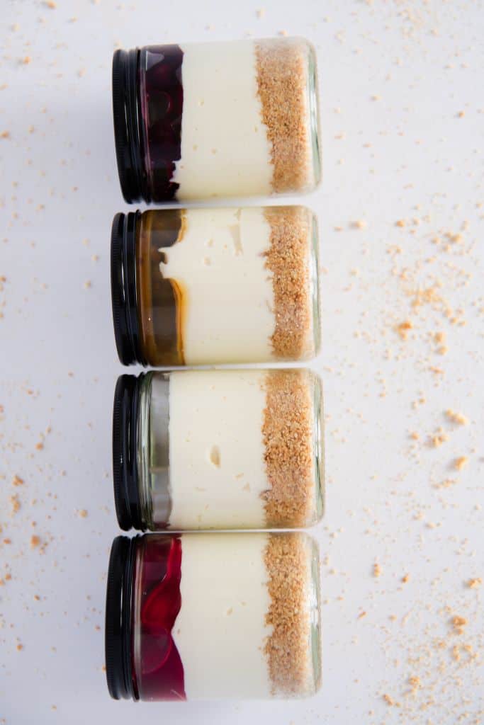 four jars of no-bake cheesecake laying on their sides