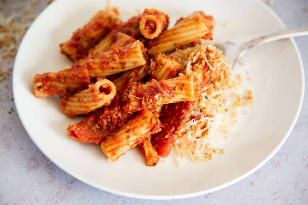 a plate of pizza pasta with a fork on it 