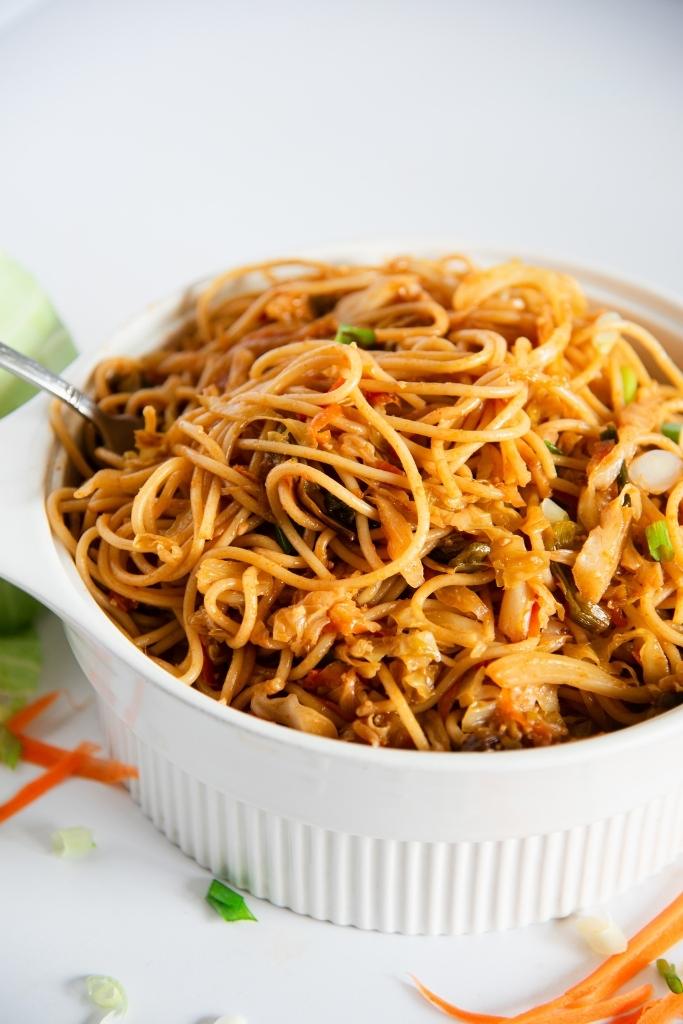 a dish of cabbage noodles with a fork in it 