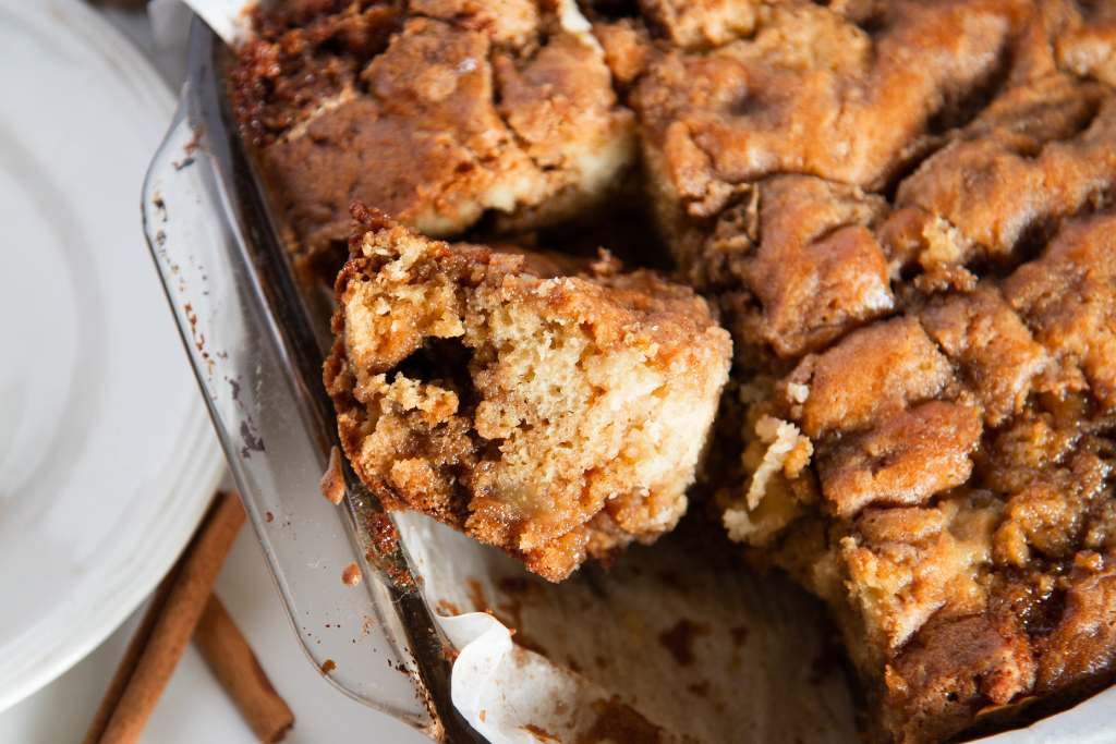 a close up of a piece of coffee cake turned on it's side in a pan of coffee cake