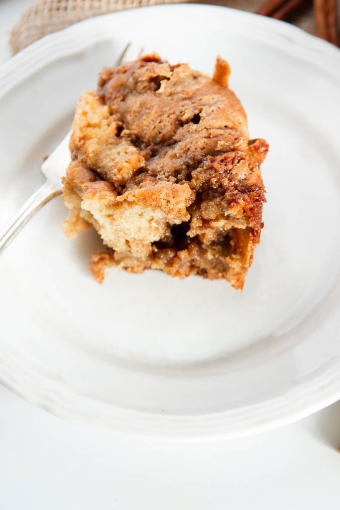a piece of coffee cake and fork on a plate
