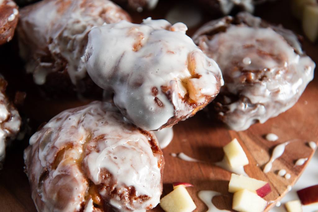 a close up of an apple fritter stacked on top of more fritters 