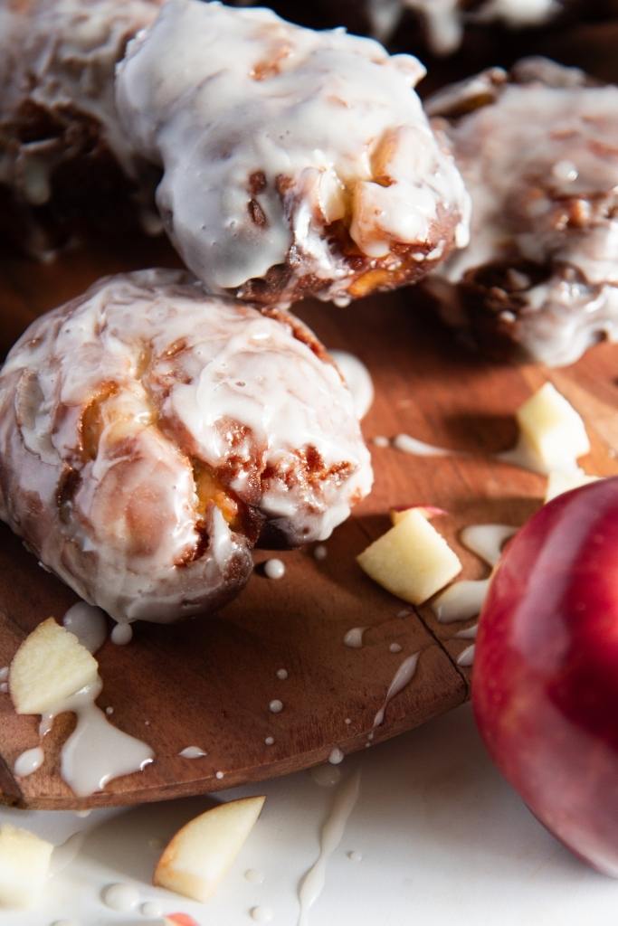 a close up of an apple fritter with an apple next to it 
