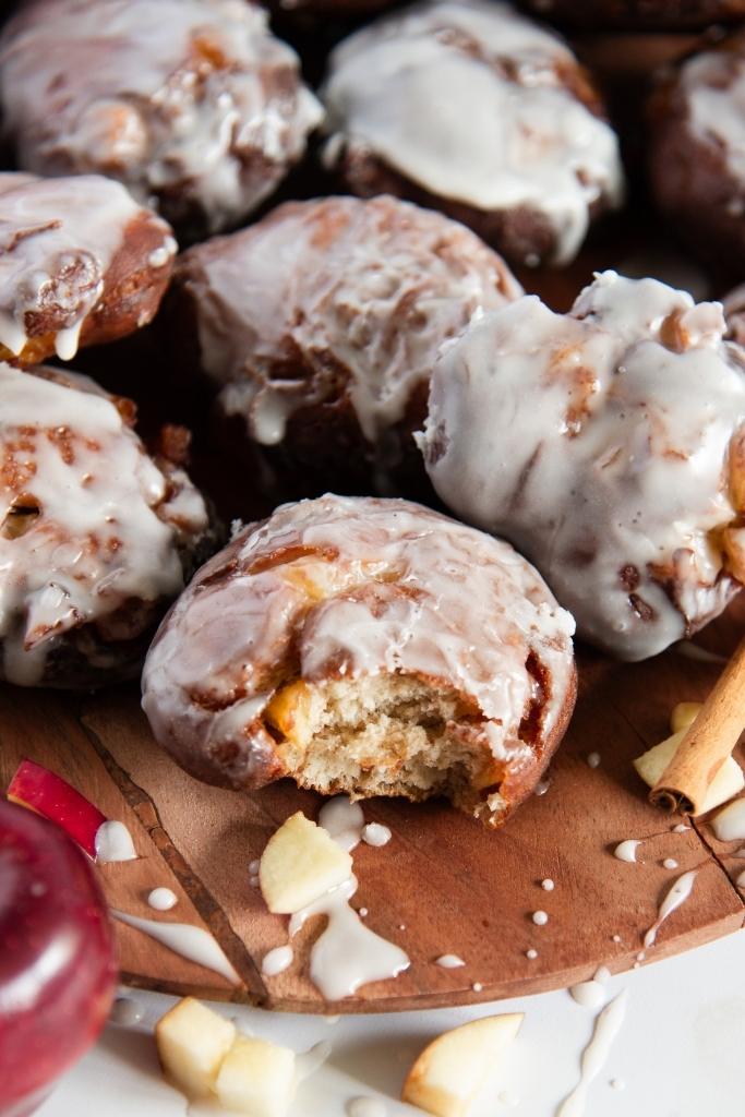 a close up of an apple fritter that ha a bite taken out o it 