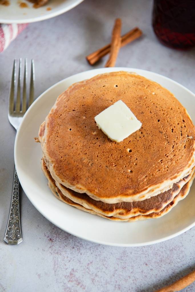 a stack of pancakes with a pat of butter on top 