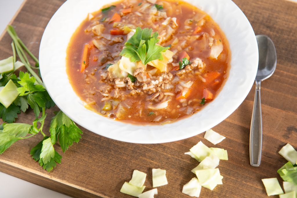 a bowl of soup with a spoon next to it 