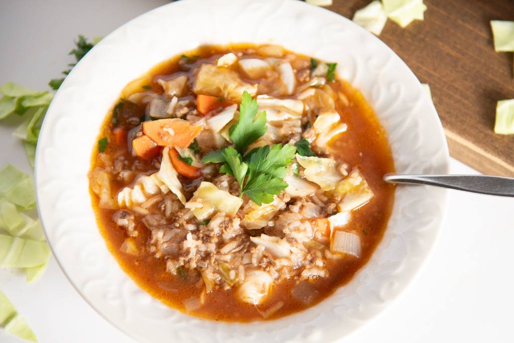 a close up of a bowl of soup with a spoon in it 