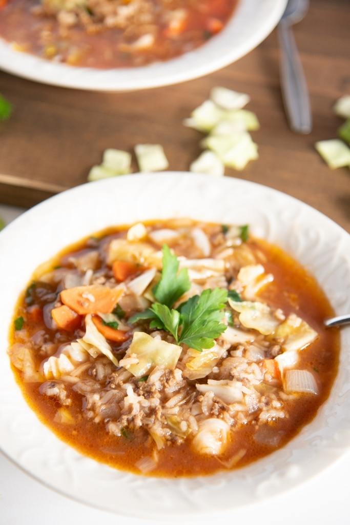 a bowl of cabbage roll soup with a spoon in it 