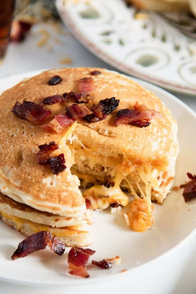 a close up of a stack of pancakes with a bite taken out of it