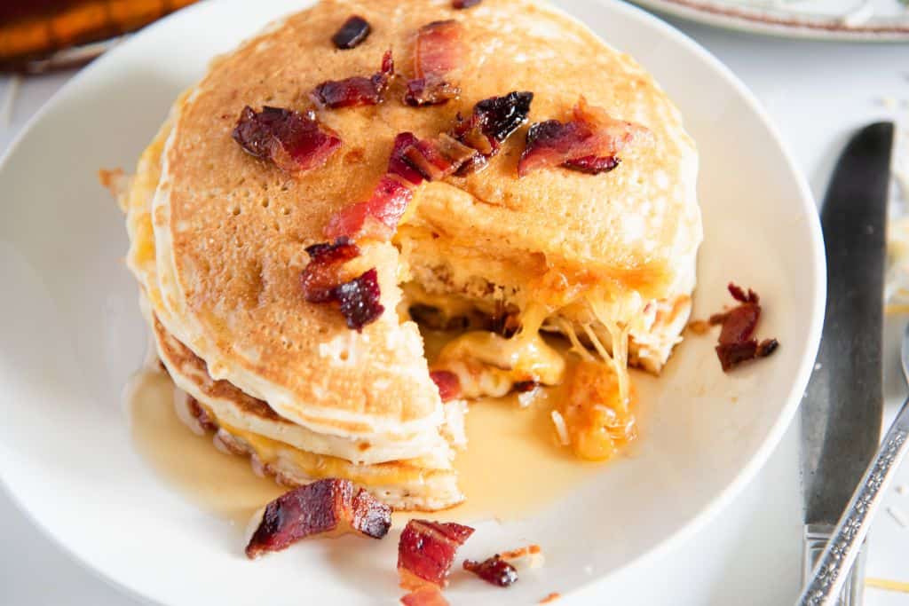 a plate of grilled cheese pancakes with syrup on top