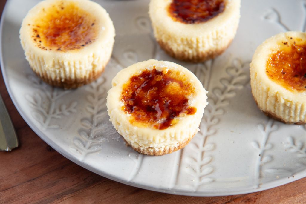 a close up of mini creme brulee cheesecake on a plate