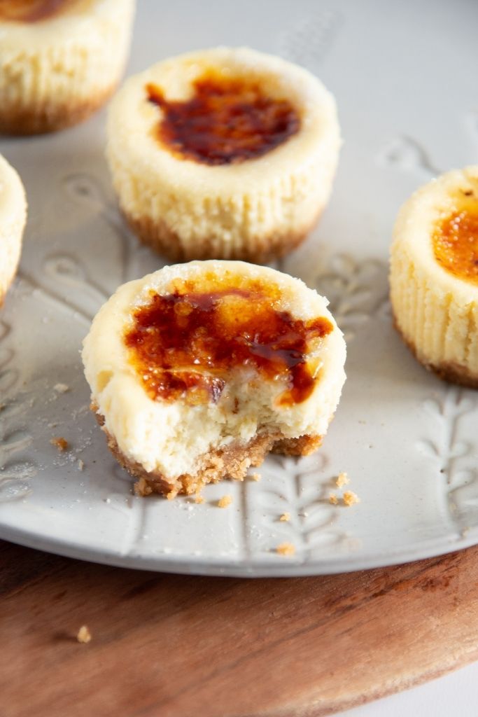 a creme brulee cheesecake on a plate with a bite taken out of it