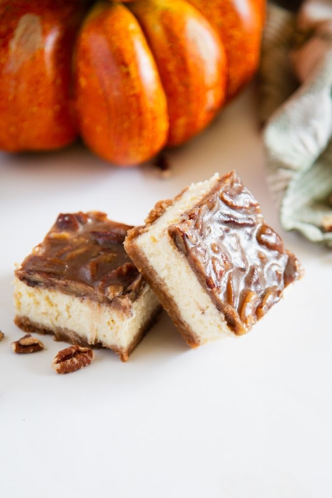 two cheesecake bars in front of pumpkin decoration