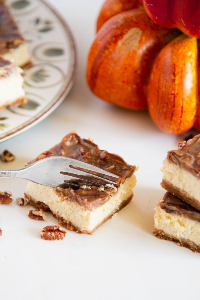 a fork cutting into a cheesecake bar
