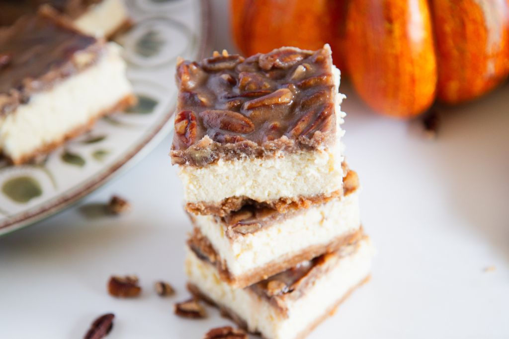 a close up of a stack of cheesecake bars