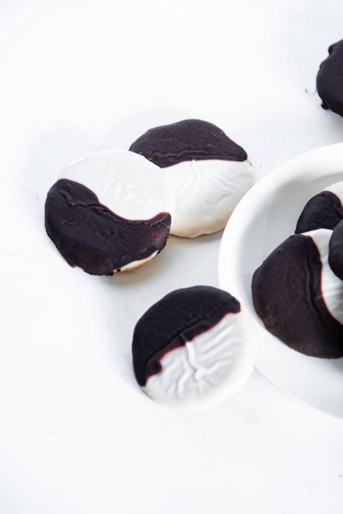 two plate and white cookies, next to a plate of cookies