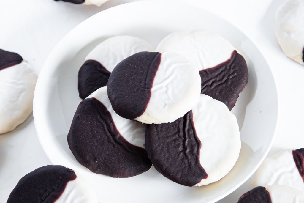 a close up of a plate of black and white cookies