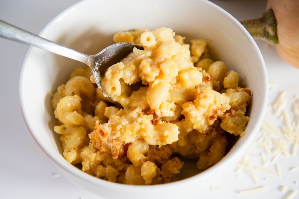 a bowl of mac and cheese with a spoon in it 