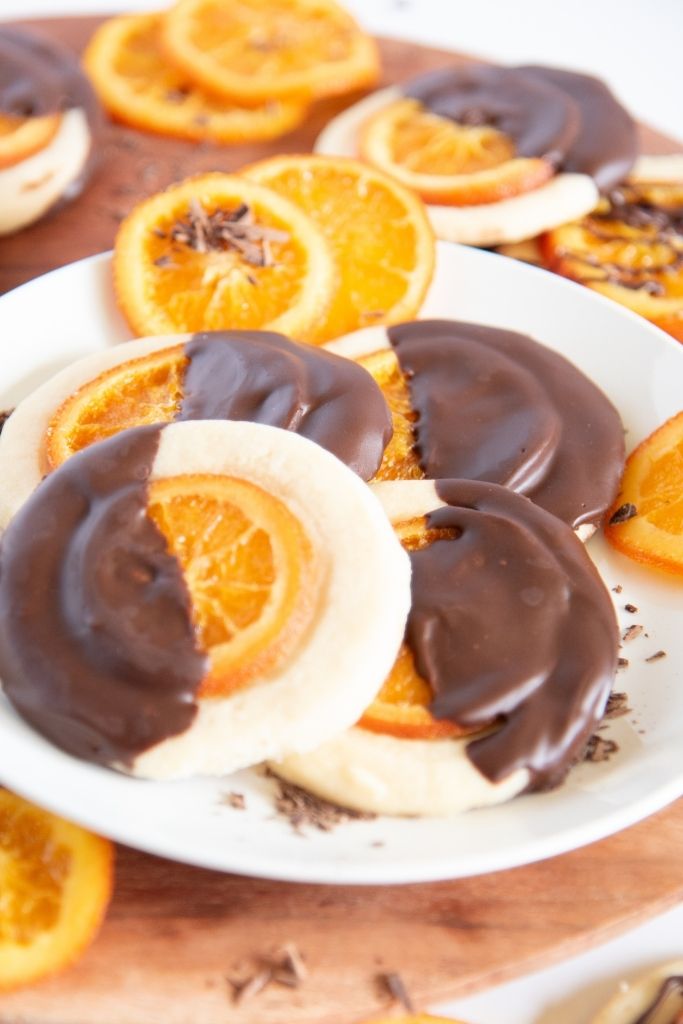 a plate of shortbread cookies with candied orange slices next to it 
