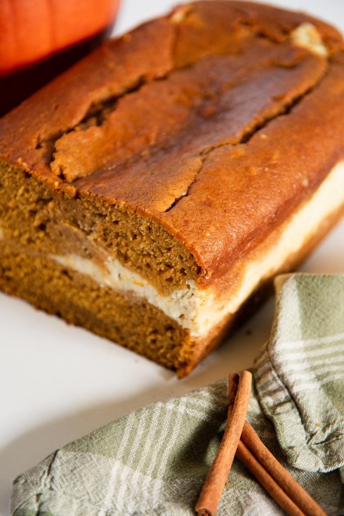a close up angled picture of a loaf of pumpkin bread