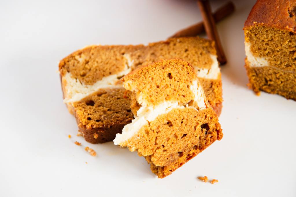 a slice of pumpkin bread with a half a slice stacked on top of it 
