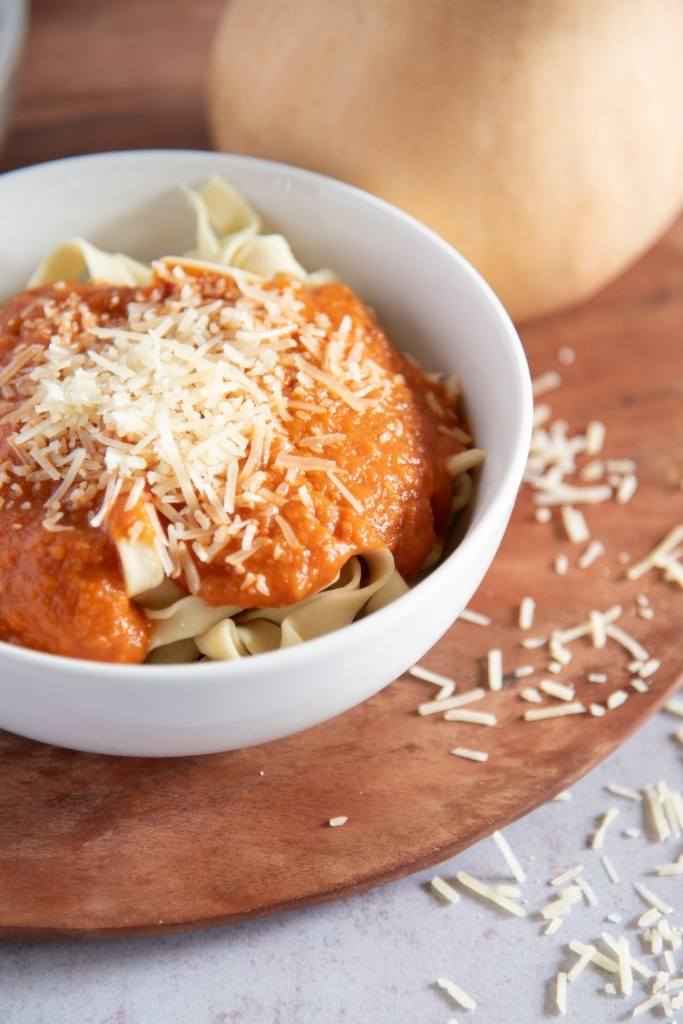 a close up on s bowl of noodles with sauce on top 