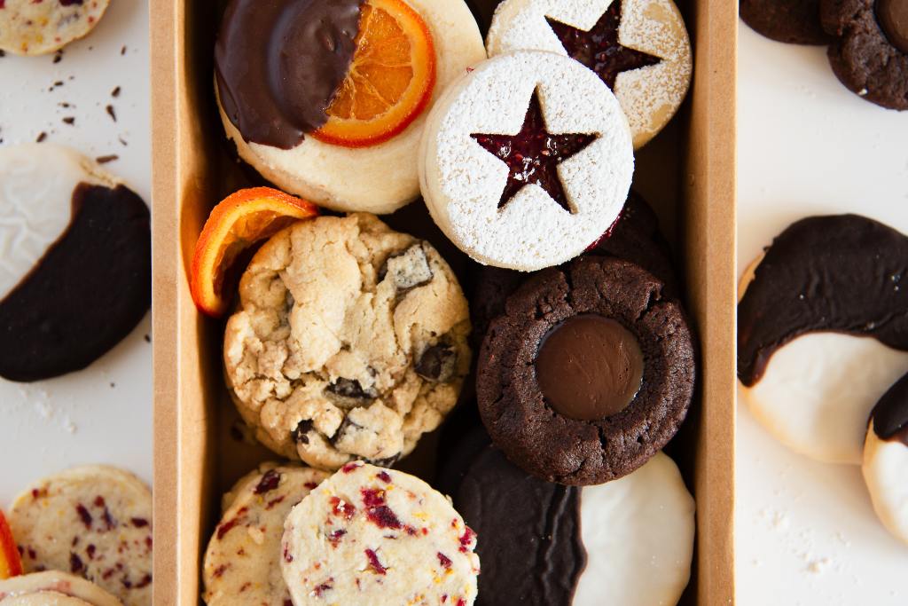 a close up of a cookie box with more cookies set around it 