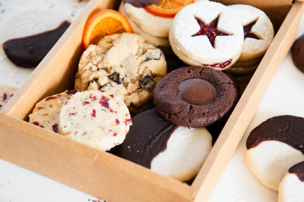 a cookie box with more cookies set around it 