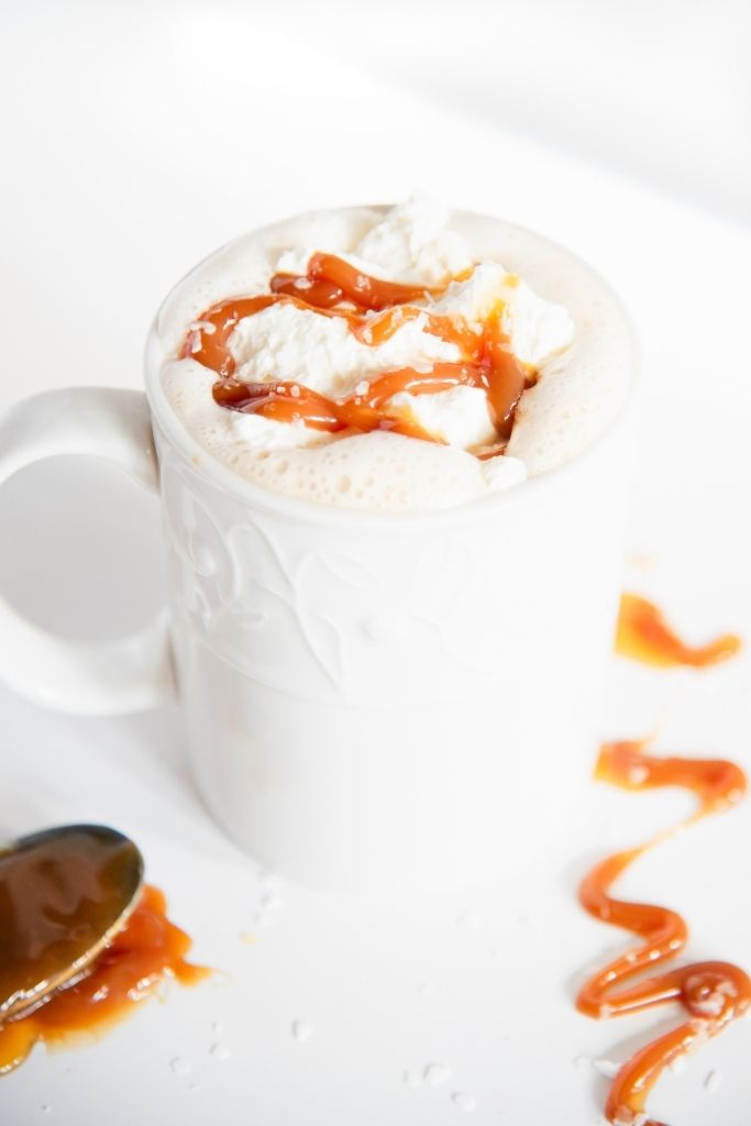 a latte with whipped cream and caramel on top 