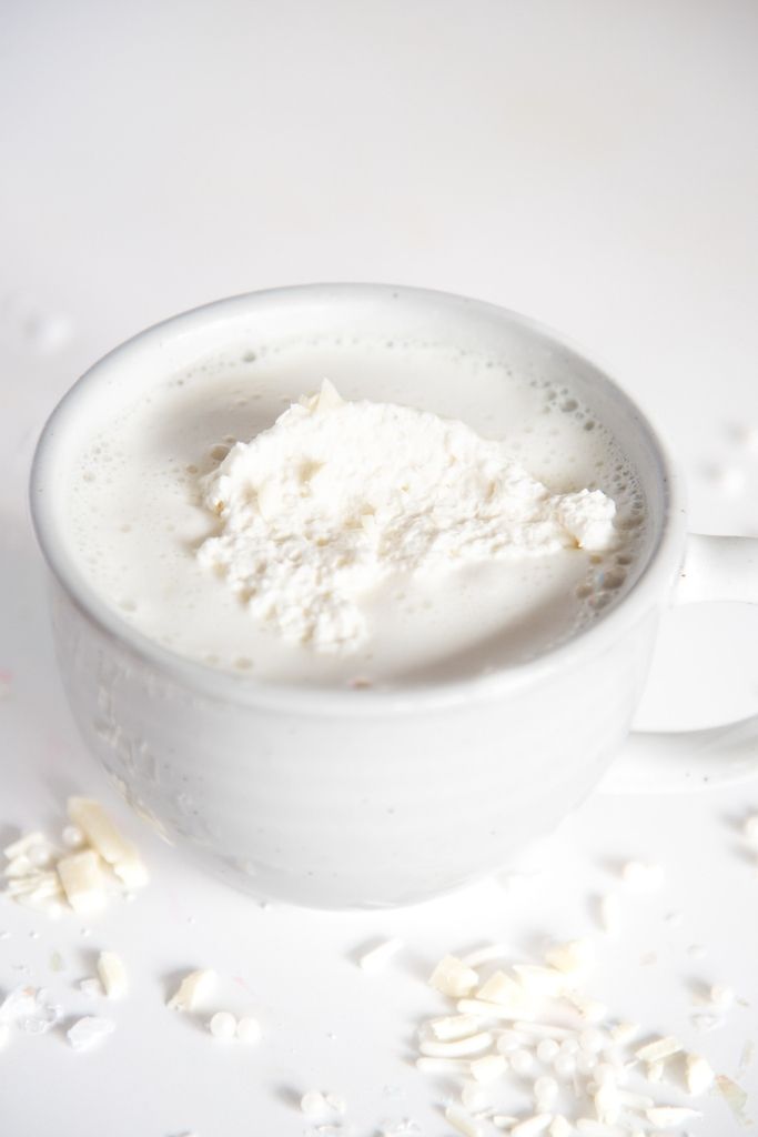 a cup of white hot chocolate with whipped cream on top 