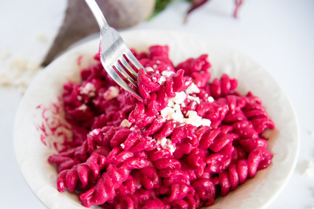 a close up of a fork full of pasta 