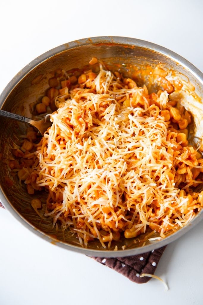 a pan noodles with cheese on top of them 