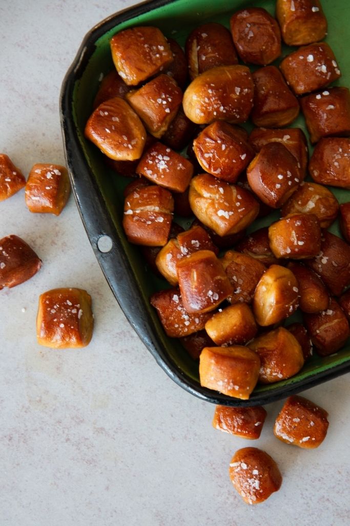 a pan of pretzel bites, there also some on the table next to the pan