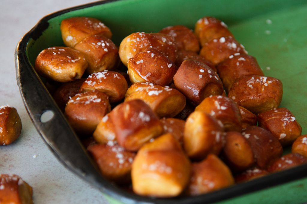 a green dish full of pretzel bites