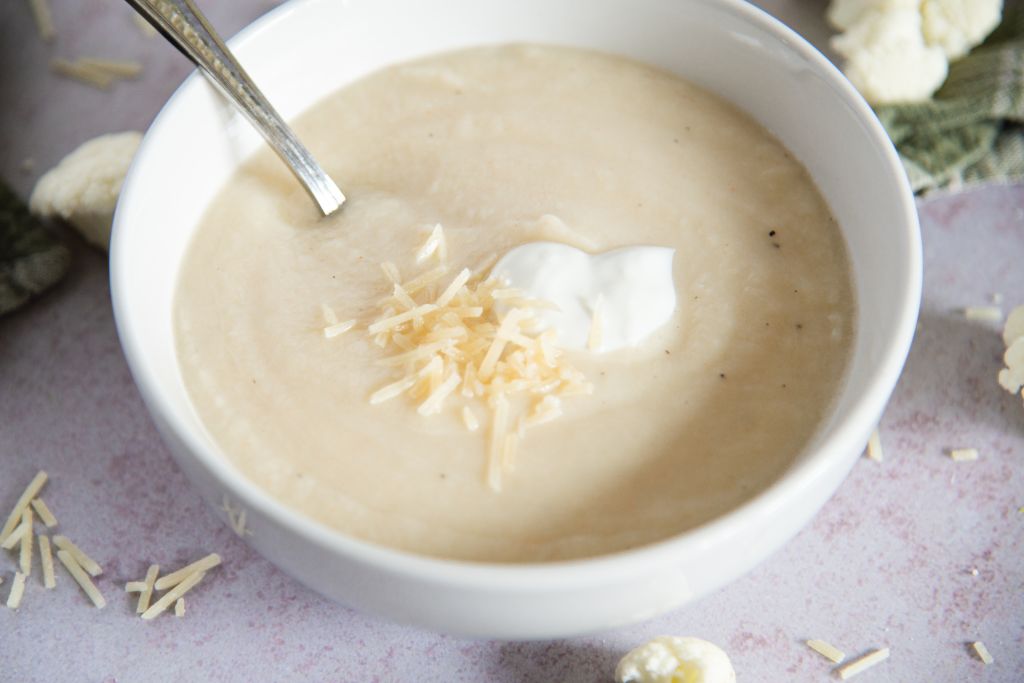 a close up of a bowl of soup with a spoon in it 