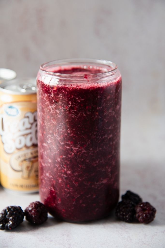 a blackberry slushy with blackberries around it 