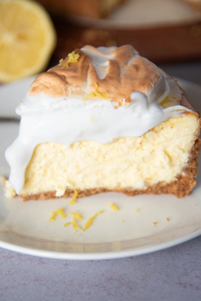 a close up of a piece of lemon meringue cheesecake on a plate