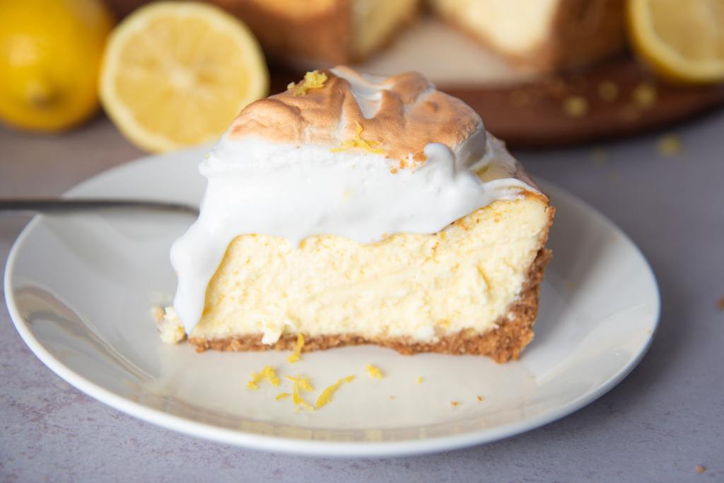 a piece of lemon meringue cheesecake on a plate