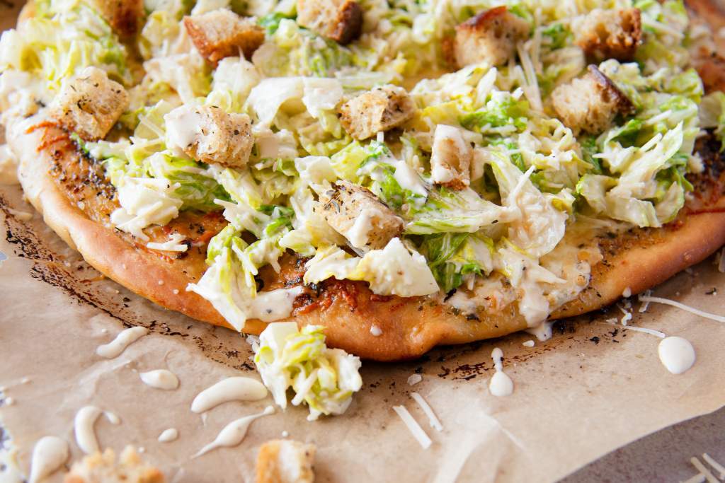a close up of  Caesar salad pizze 