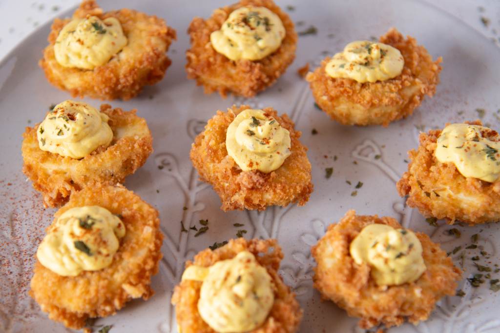 a plate of deep fried deviled eggs