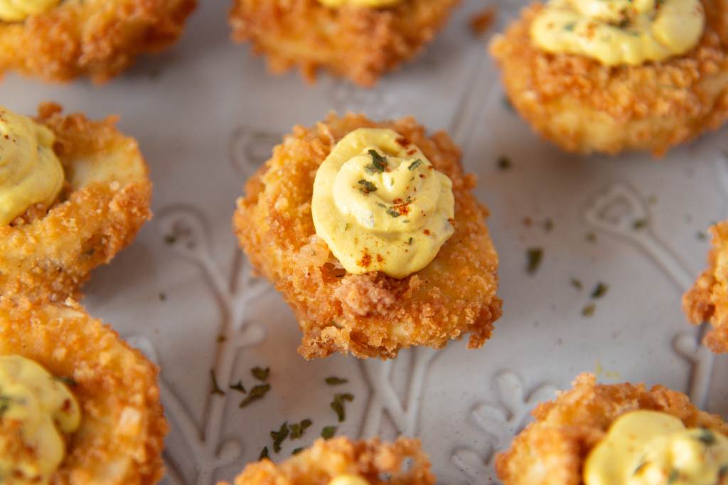 a close up of deep fried deviled eggs on a plate