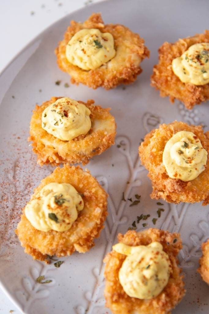 a plate of deep fried deviled eggs