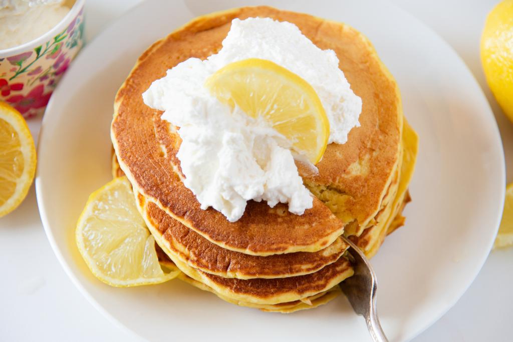 a stack of pancakes being cut into a with a fork