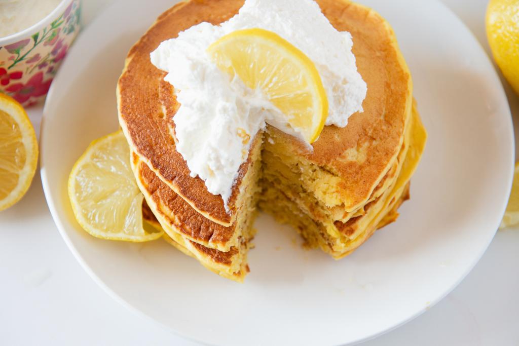 a stalk of pancakes that has a slice cut out of it. 
