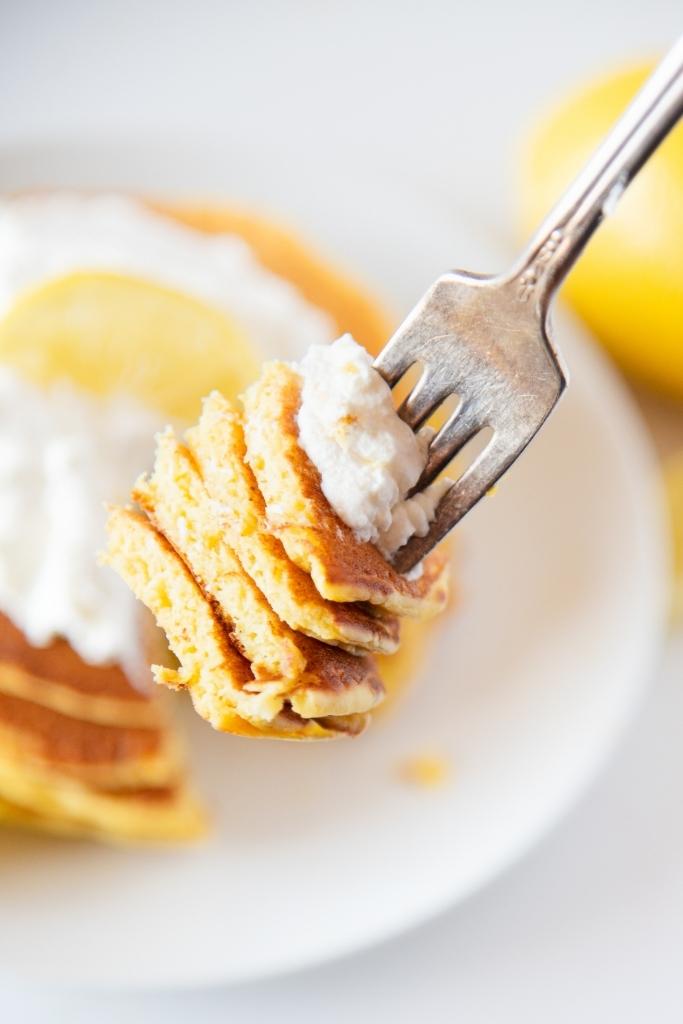 a close up of a bite of pancake on fork 