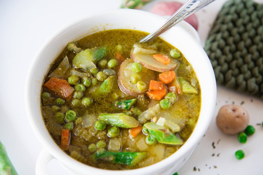 a bowl of spring time soup with a spoon in it 