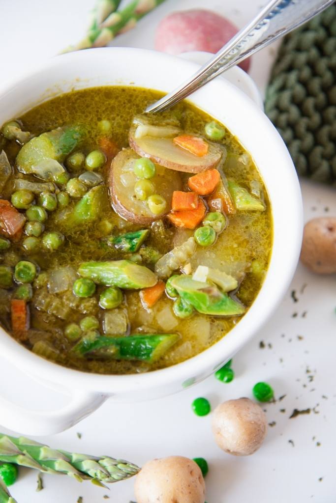 a bowl of springtime soup with a spoon in it 