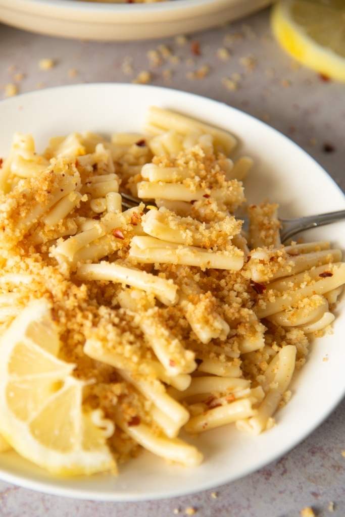 a close up of a plate of pasta with a fork in it